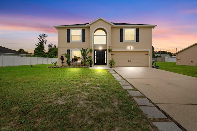 view of front property featuring a garage and a lawn