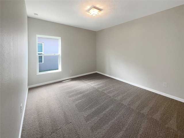 spare room with carpet flooring and baseboards