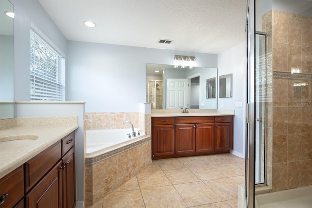 bathroom featuring tile patterned flooring, separate shower and tub, and vanity