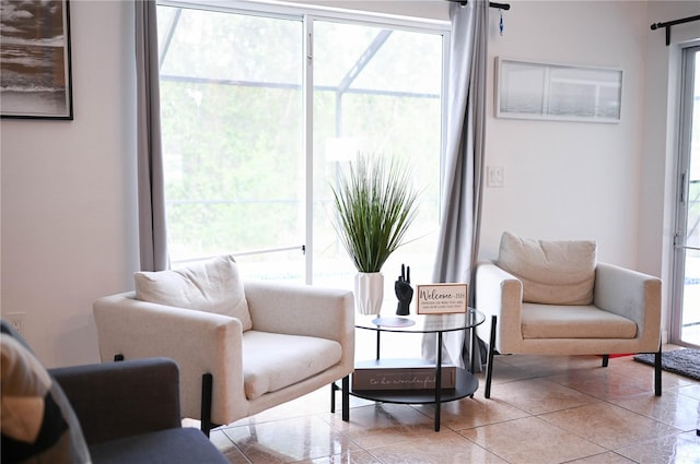 sitting room featuring a wealth of natural light and light tile patterned floors