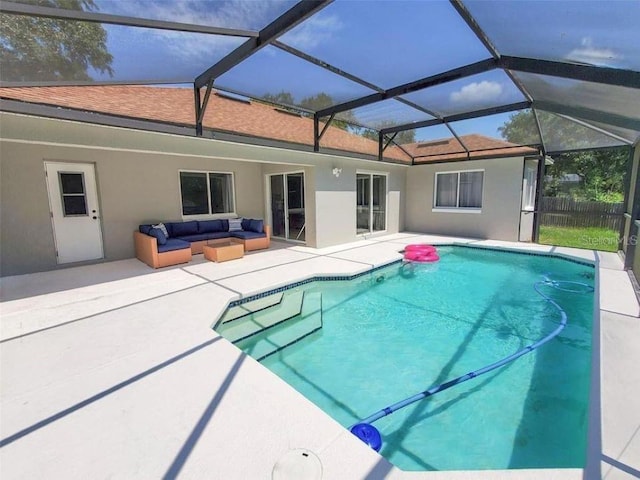 view of swimming pool featuring glass enclosure, a patio area, and an outdoor hangout area