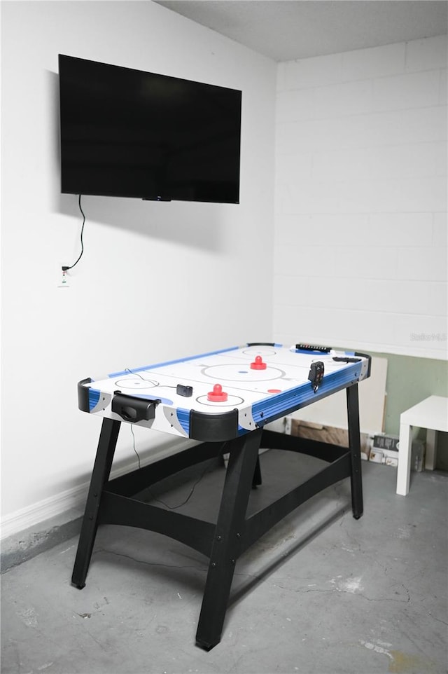 recreation room with concrete floors