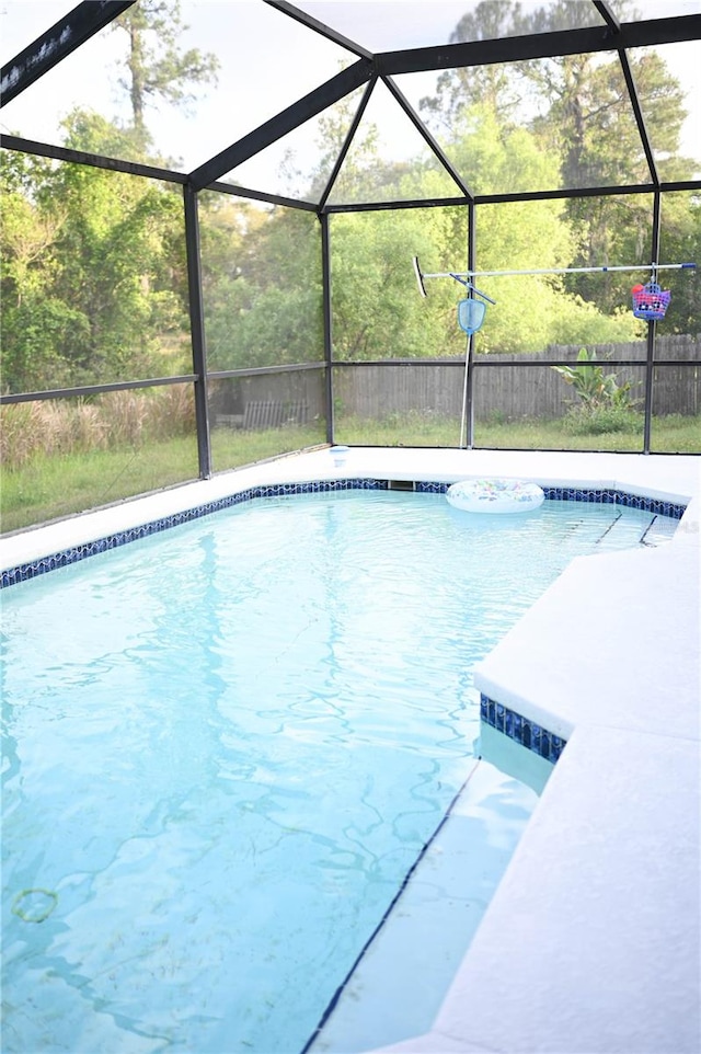 view of pool with glass enclosure