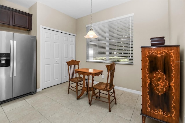 dining space with light tile patterned flooring and baseboards