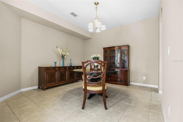 dining area featuring an inviting chandelier, baseboards, light tile patterned floors, and visible vents