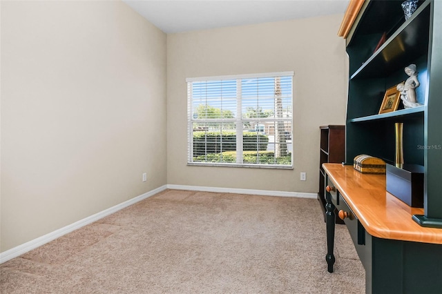 carpeted office space featuring baseboards