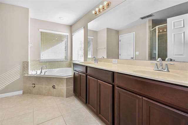 full bath with a stall shower, a garden tub, a sink, and tile patterned floors