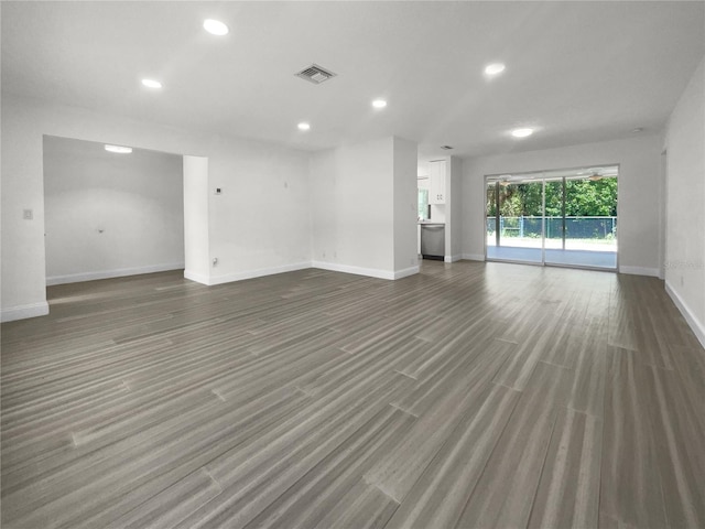 unfurnished living room featuring baseboards, visible vents, wood finished floors, and recessed lighting