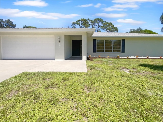 view of front of house featuring a garage, a front lawn, concrete driveway, and stucco siding