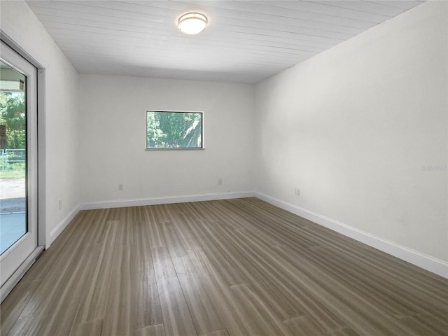 empty room featuring baseboards and wood finished floors