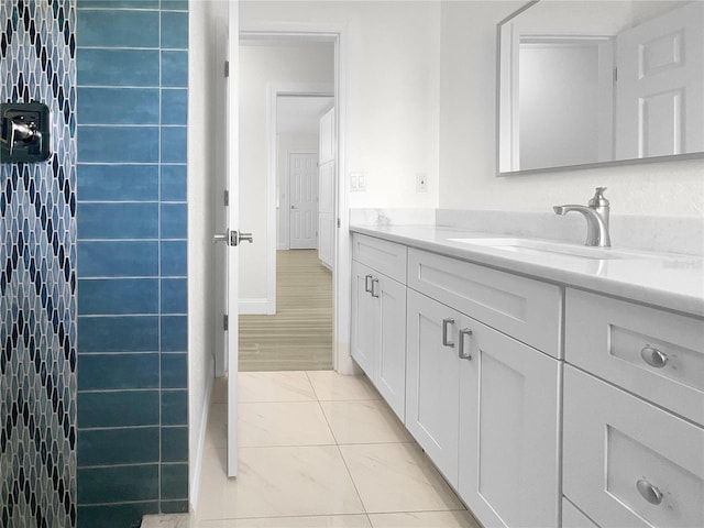 bathroom with tile patterned flooring, vanity, and baseboards