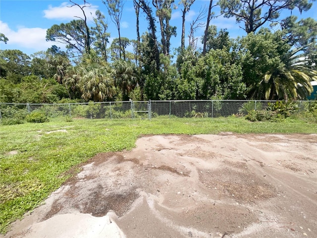 view of home's community featuring a yard and fence