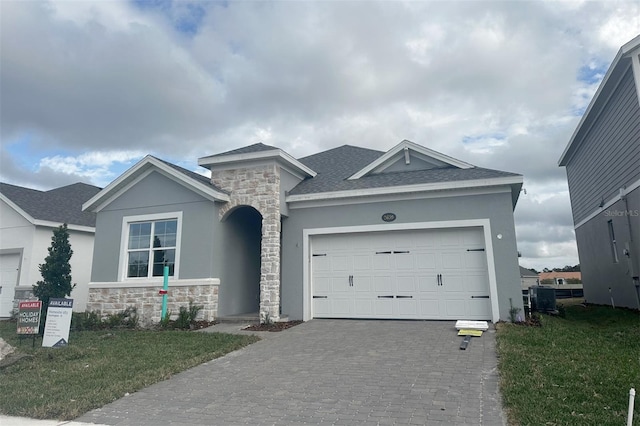 view of front facade with a garage and a front lawn