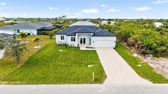 view of front of property featuring a garage and a front yard