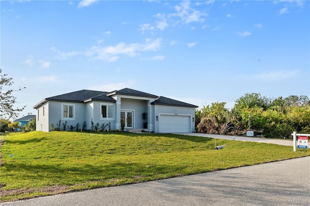 view of front of property featuring a garage and a front lawn