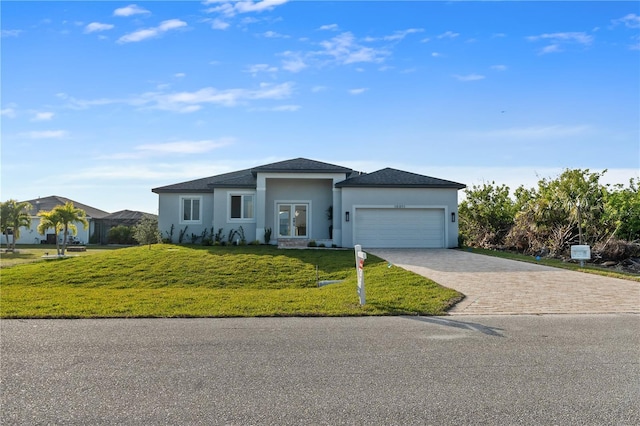 view of front of house with a garage and a front lawn