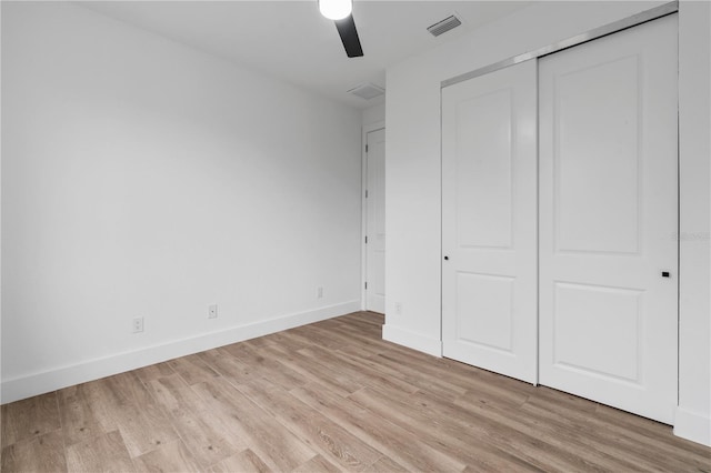 unfurnished bedroom featuring a closet, ceiling fan, and light hardwood / wood-style flooring