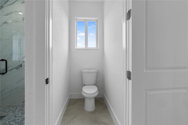 bathroom with toilet and a shower with shower door