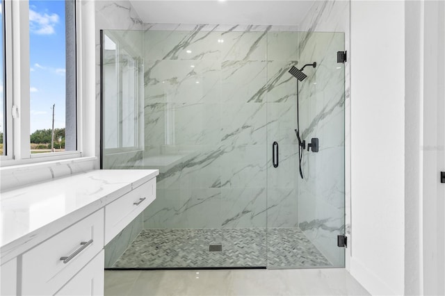 bathroom featuring vanity and a shower with shower door