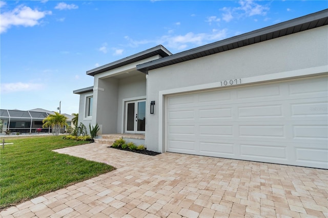 view of front of house with a garage and a front lawn