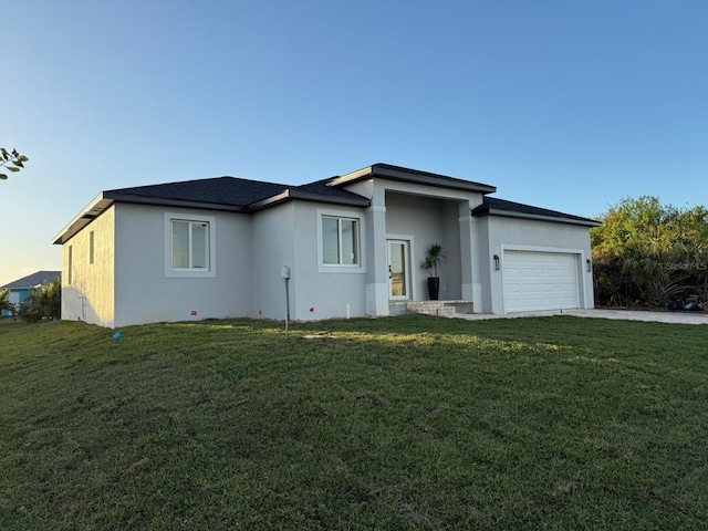 view of front of house with a garage and a front yard