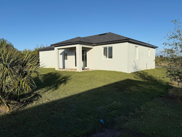 back of house featuring a lawn