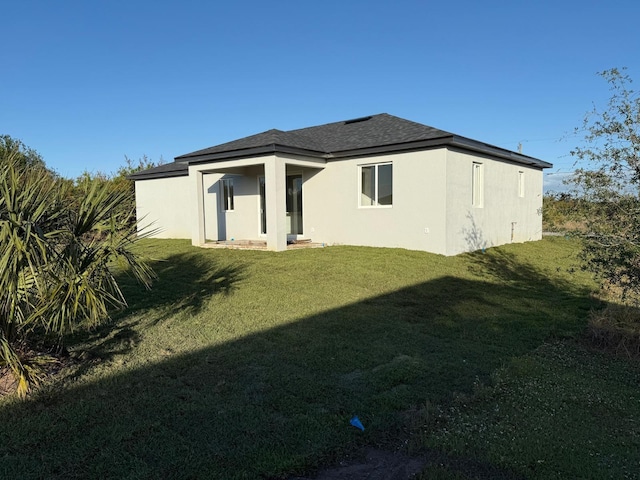 rear view of property with a yard