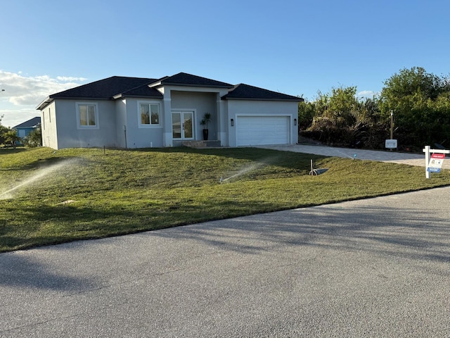 single story home with a garage and a front yard