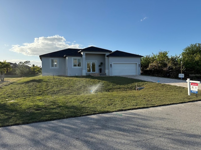 view of front facade with a garage and a front yard