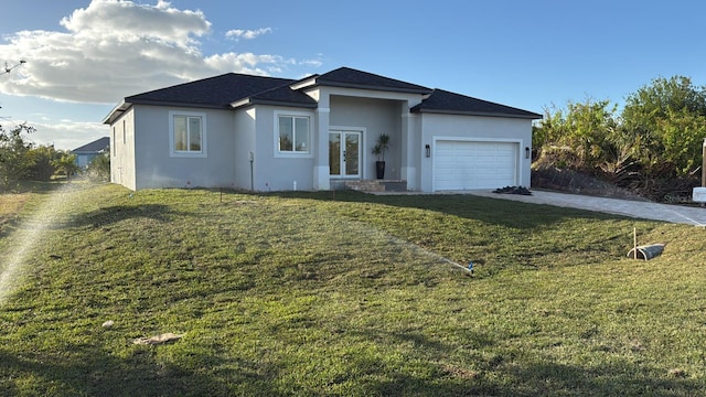 view of front of house with a garage, a front yard, and french doors