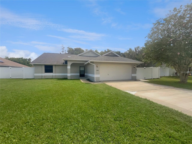 single story home featuring stucco siding, concrete driveway, a front yard, and fence