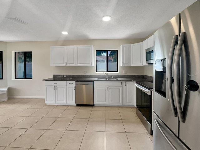 kitchen featuring white cabinets, stainless steel appliances, and sink