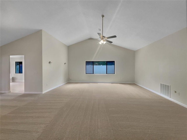 empty room featuring ceiling fan, light carpet, and vaulted ceiling