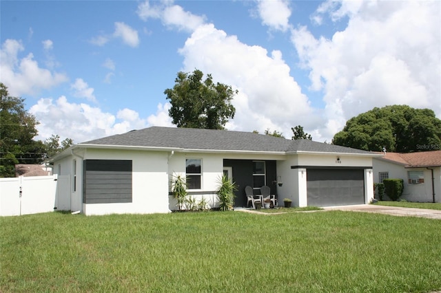 ranch-style home featuring fence, driveway, an attached garage, stucco siding, and a front lawn