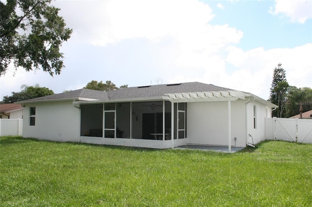 rear view of property with a gate, a yard, a fenced backyard, and a sunroom