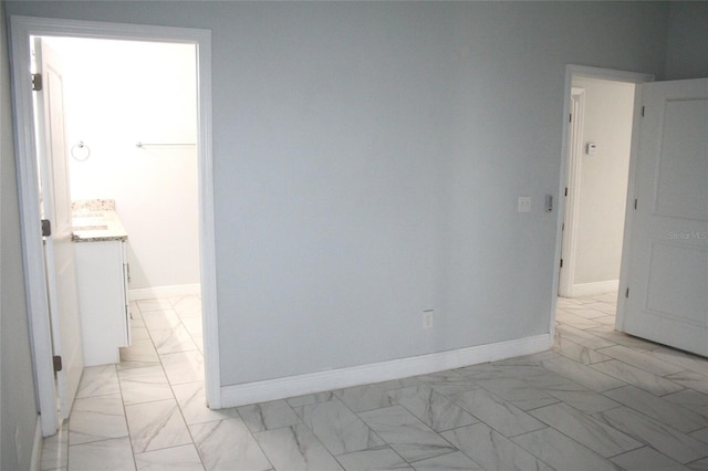 empty room with baseboards and marble finish floor