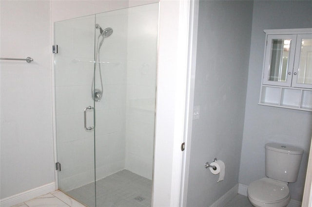 full bath with baseboards, toilet, and a stall shower