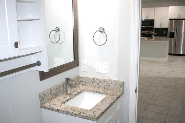 bathroom with backsplash and vanity