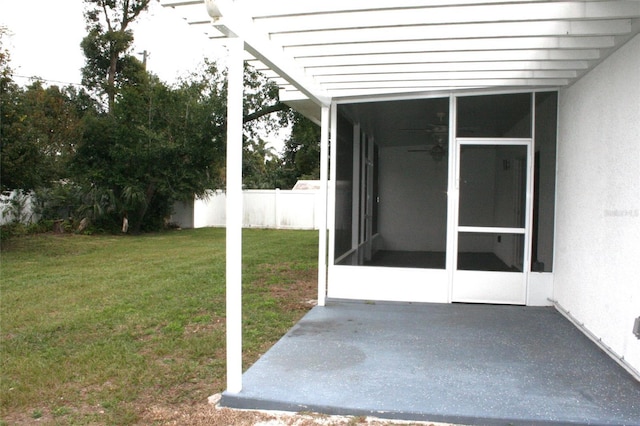 exterior space featuring stucco siding, a patio, a lawn, and fence