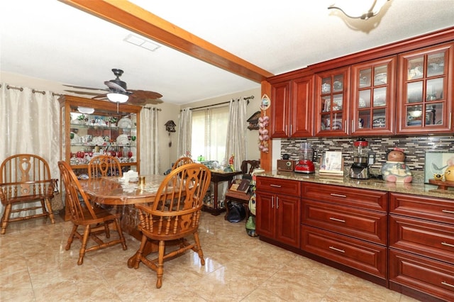 dining area featuring beam ceiling and ceiling fan