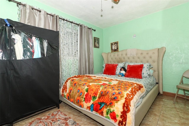 bedroom featuring ceiling fan and light tile patterned floors