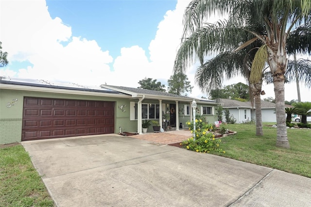 ranch-style home featuring a garage and a front lawn