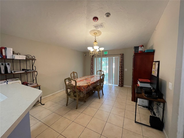 dining space featuring visible vents, a notable chandelier, baseboards, and light tile patterned floors