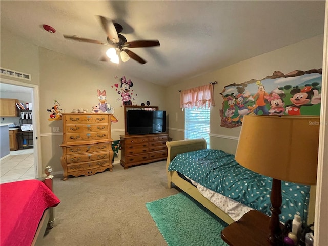 bedroom with lofted ceiling, light carpet, visible vents, and a ceiling fan