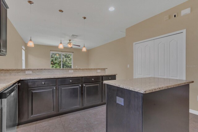 kitchen featuring stainless steel dishwasher, a center island, light stone countertops, and hanging light fixtures