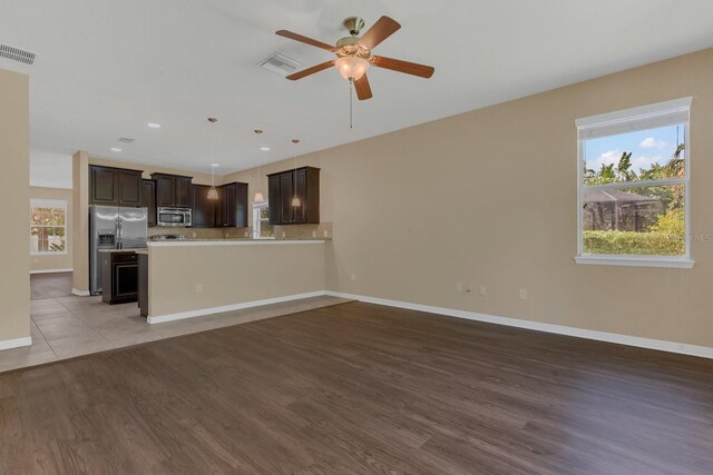 unfurnished living room featuring light hardwood / wood-style flooring and ceiling fan