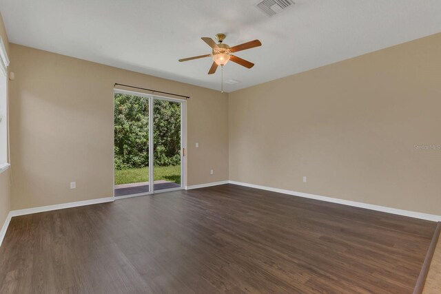 spare room featuring ceiling fan and dark hardwood / wood-style floors