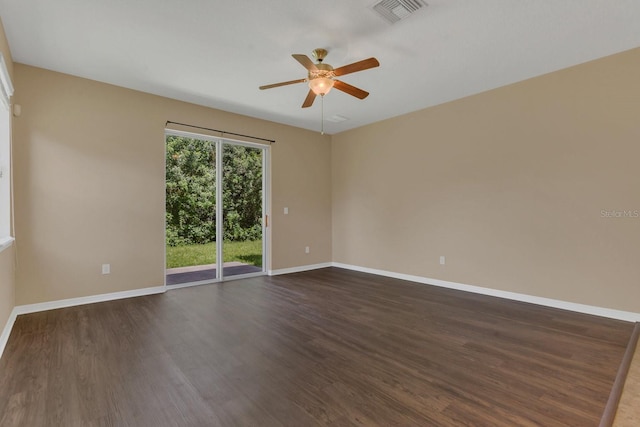 unfurnished room featuring visible vents, baseboards, dark wood-type flooring, and ceiling fan