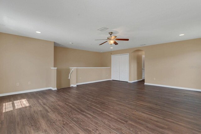 spare room with ceiling fan and dark hardwood / wood-style floors