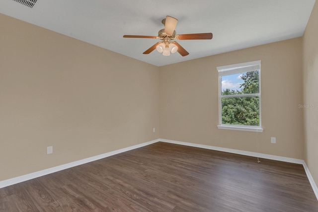 empty room featuring ceiling fan and dark hardwood / wood-style flooring